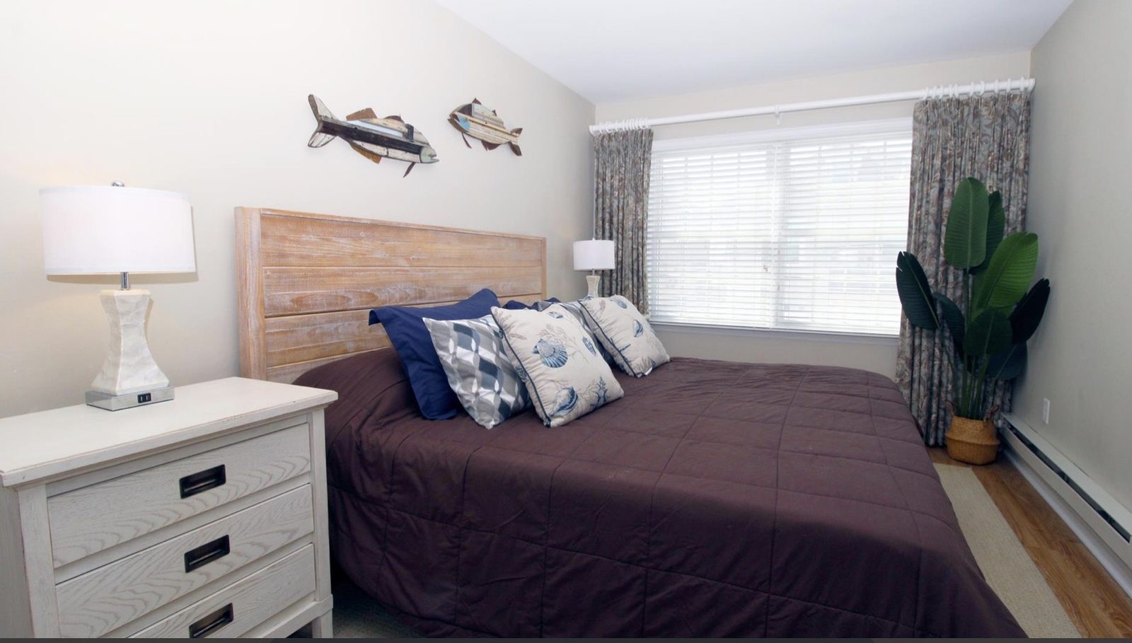 Primary bedroom with a king bed and warm coastal accents