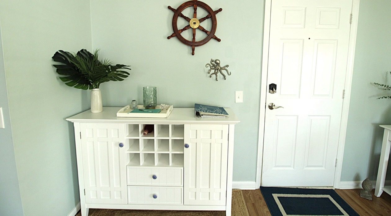 Entry with coastal decor and a console
